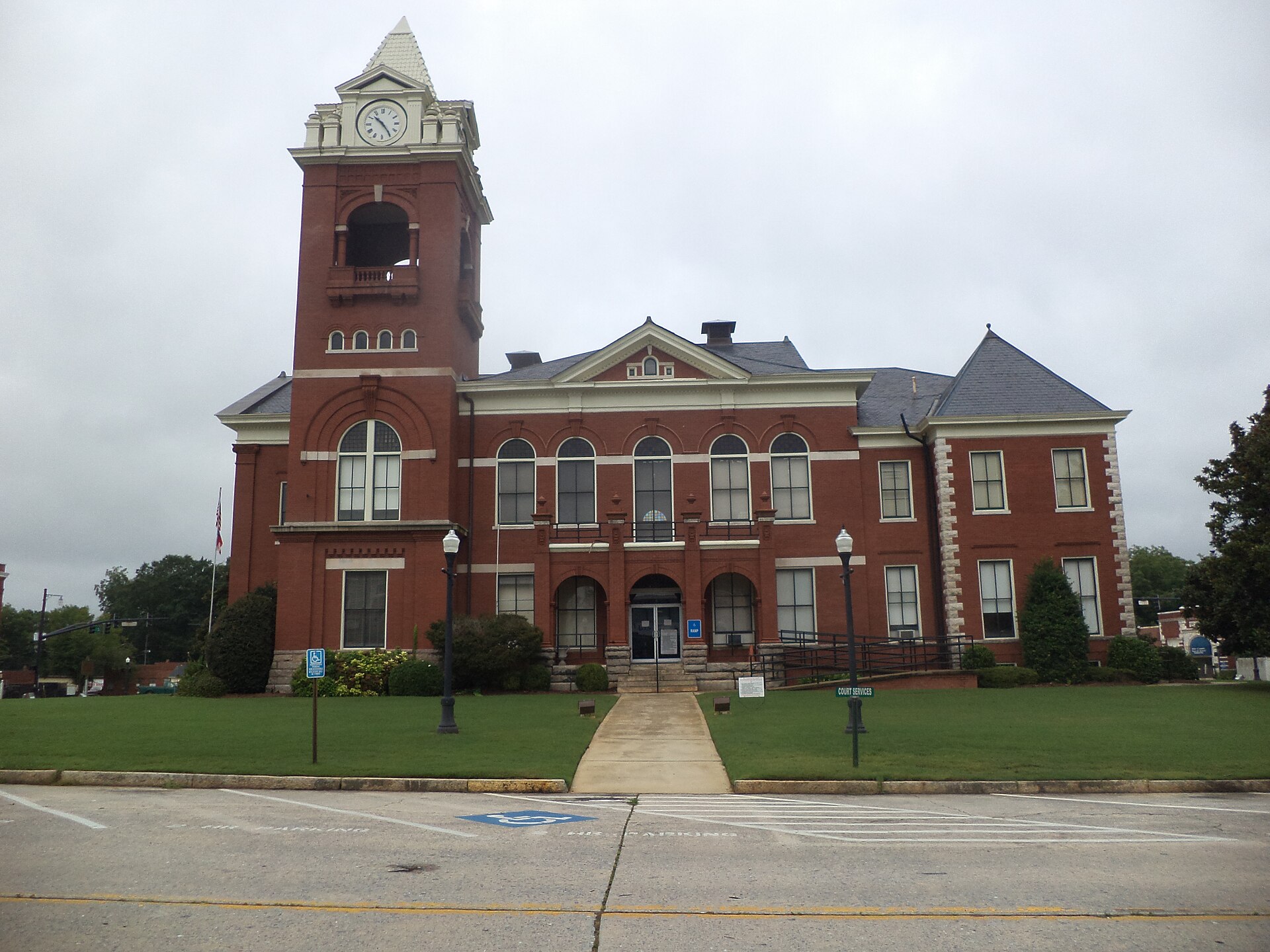 Red brick Butts County Courthouse with a clock tower in downtown Jackson, Georgia