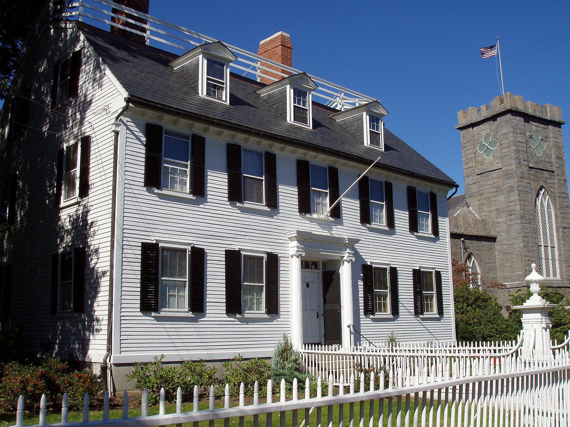 The Ropes Mansion on Essex Street in Salem, Massachusetts, a white clapboard house with black shutters behind a white picket fence